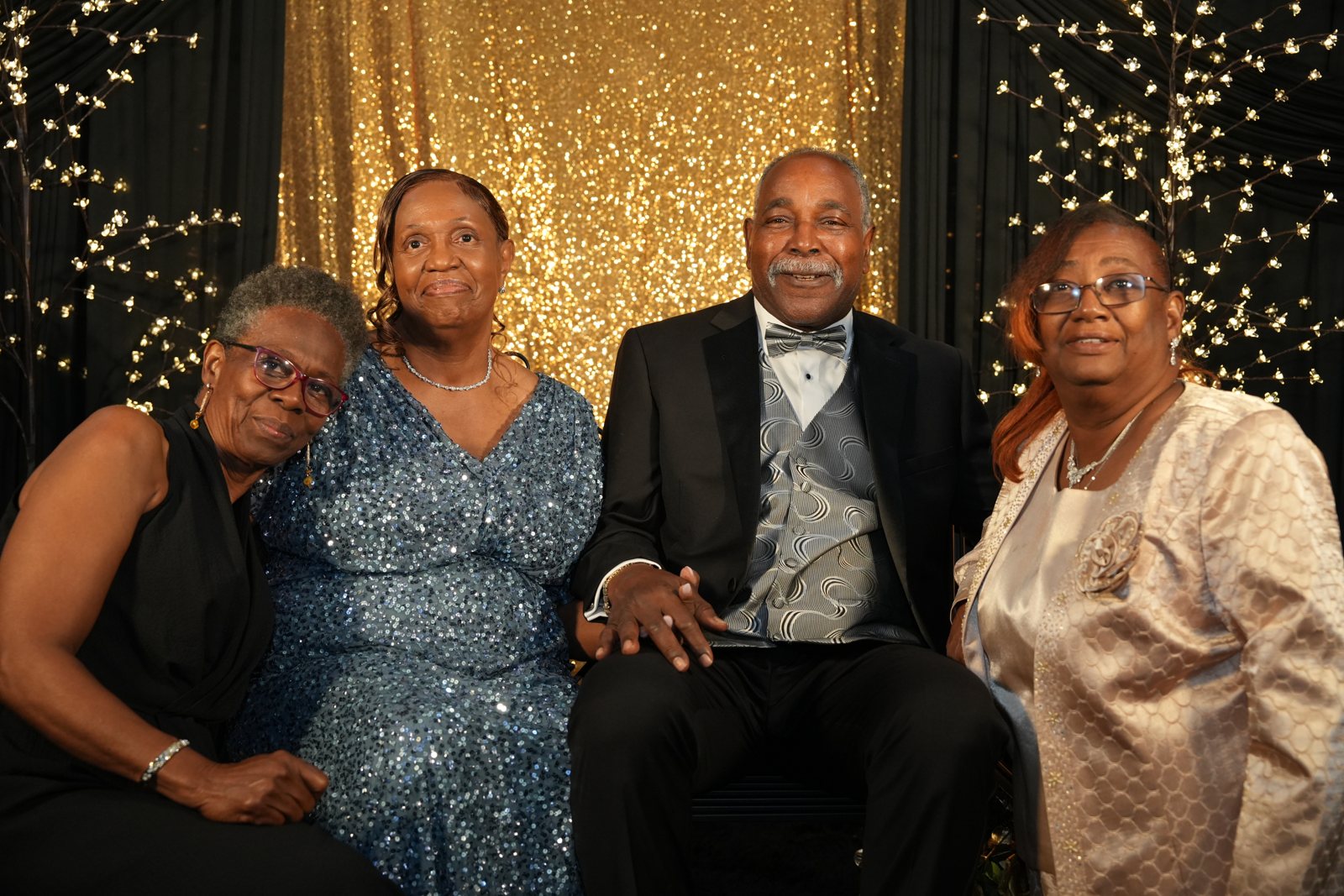 Four guests in formal dress, one in a tuxedo, at the Freedom Charity Ball