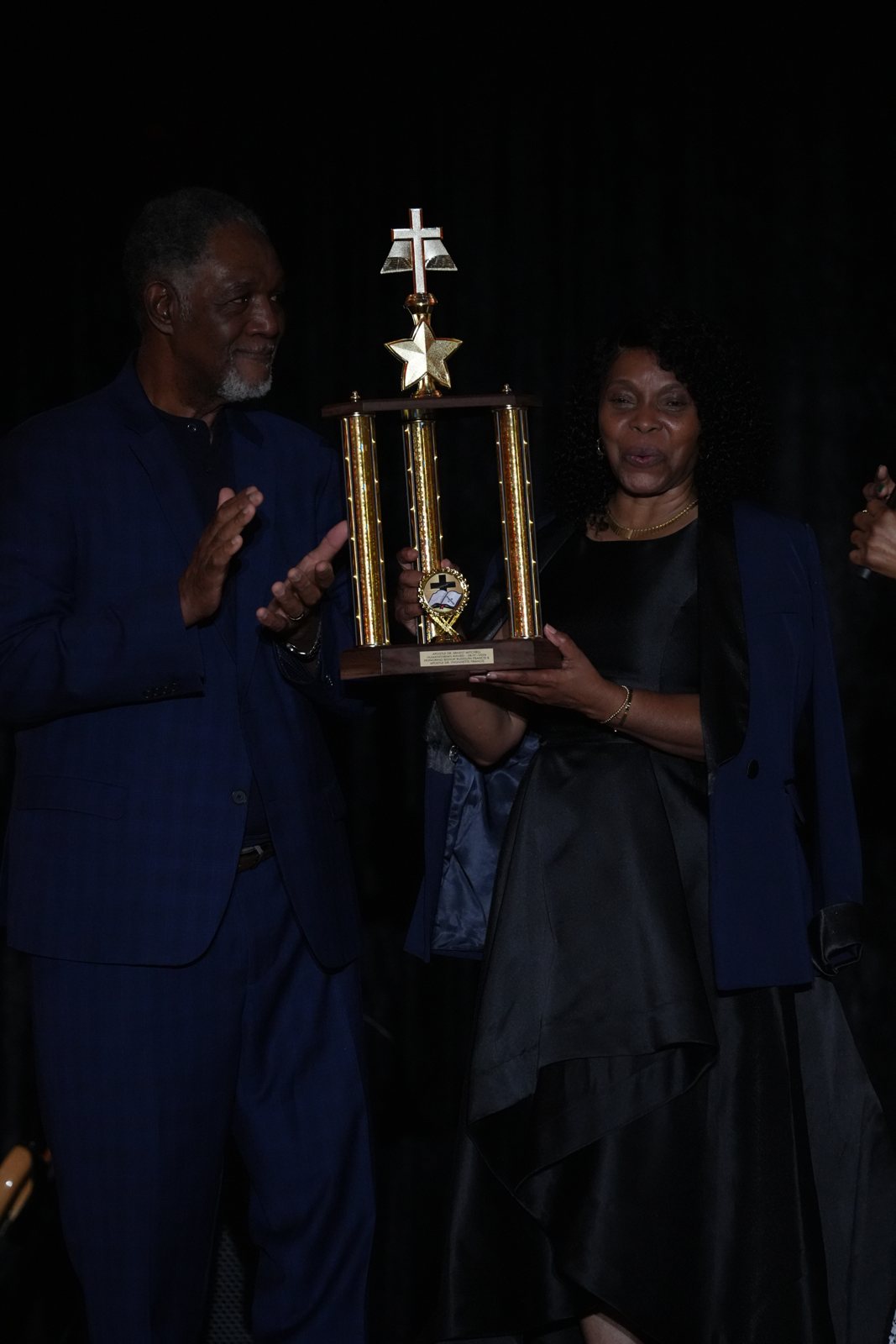 Bishop Rudolph Francis and Apostle Dr. Yvonnette Francis receive the Humanitarian Award on stage