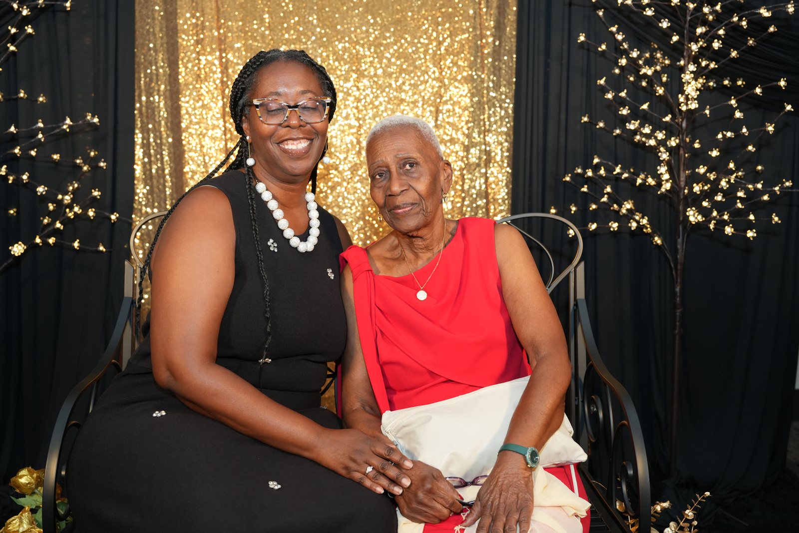 Two generations of a family stand together in formal clothing