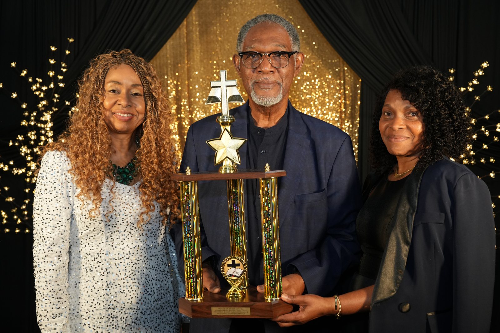 Chief Apostle Dr. Sandra Mitchell, Bishop Rudolph Francis and Apostle Dr. Yvonnette Francis with the Humanitarian Award trophy