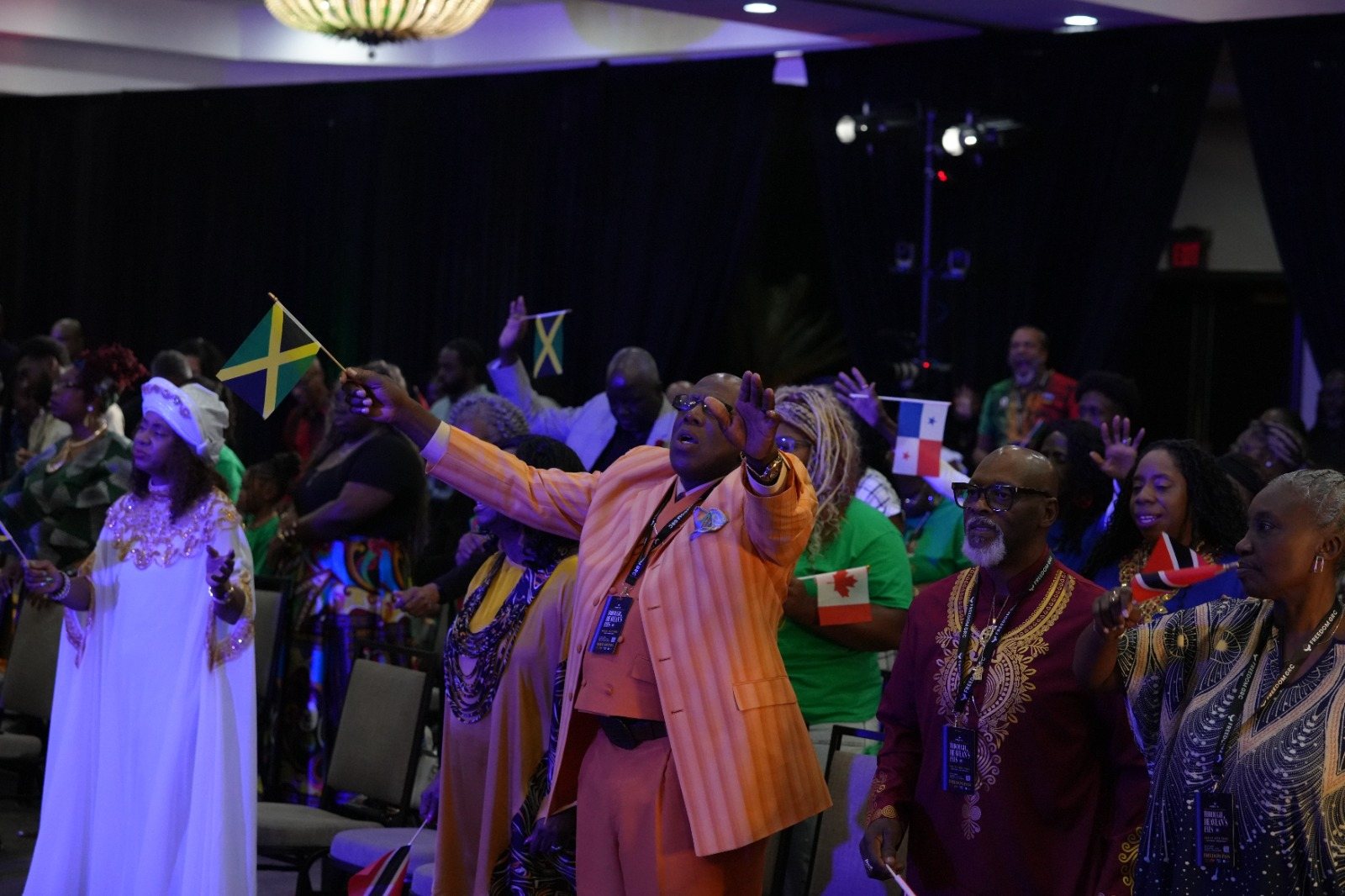 Congregants worship while holding national flags during an evening service