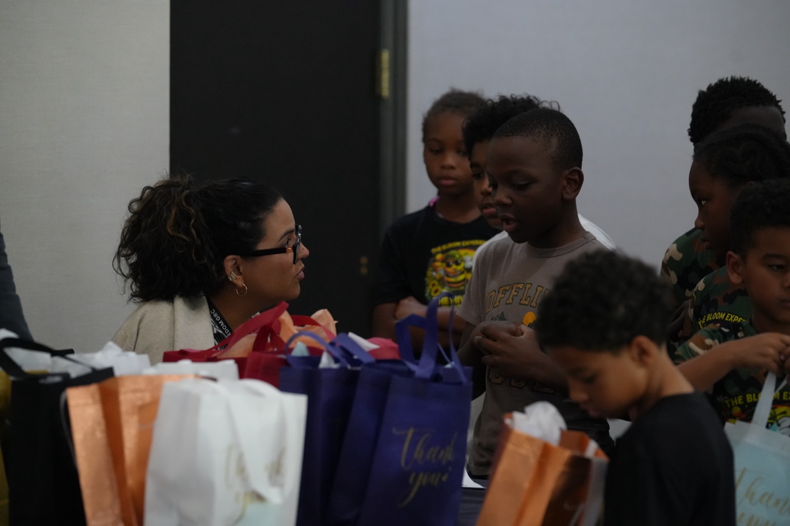 A Kids Club volunteer hands out gifts to children