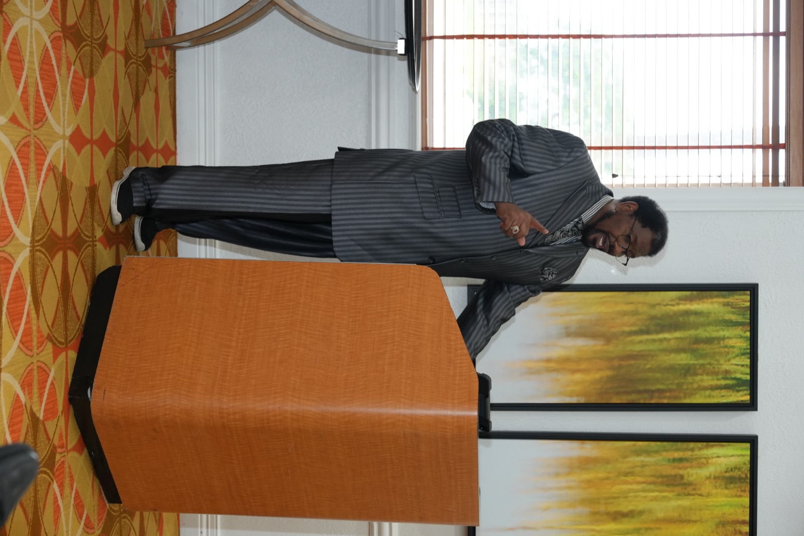 A minister teaches in a focused convention leadership room