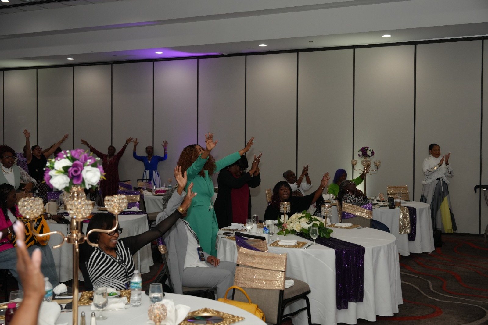 Women worship around decorated luncheon tables