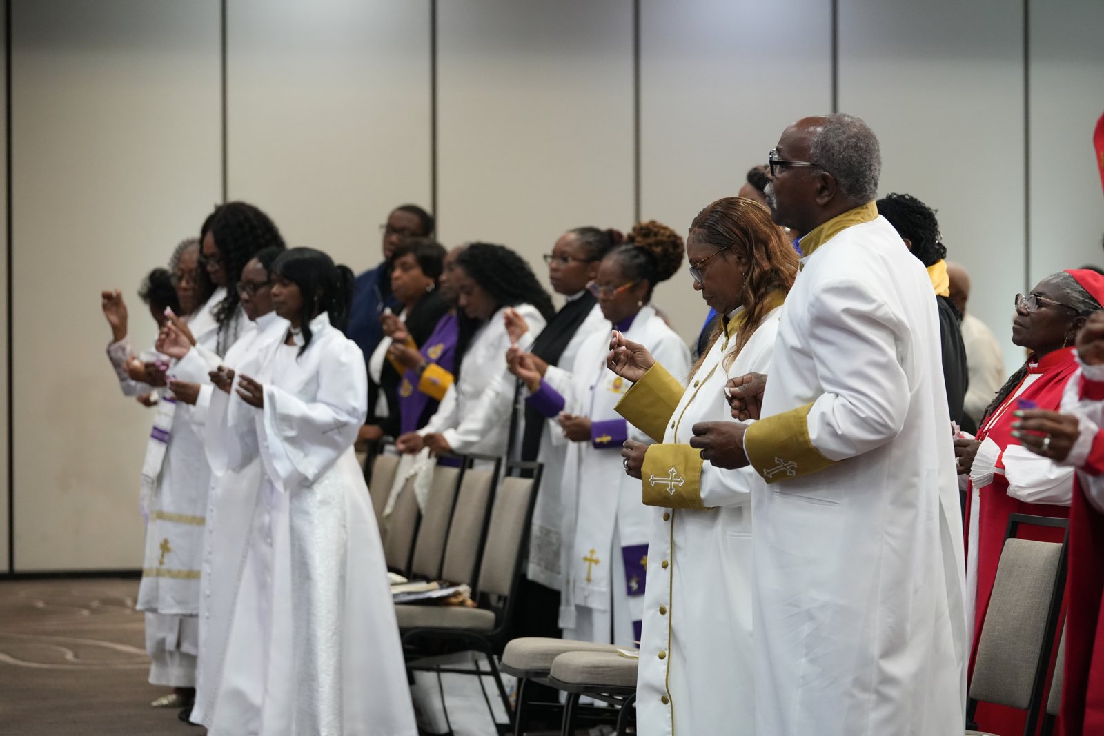 Clergy and newly ordained ministers gather after the service