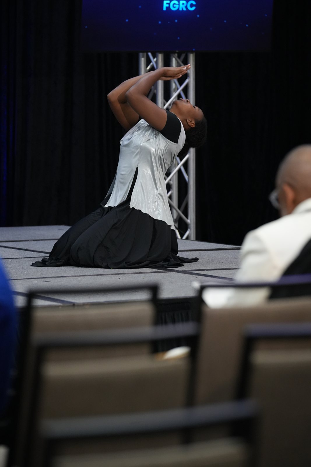 A liturgical dancer kneels during the morning service
