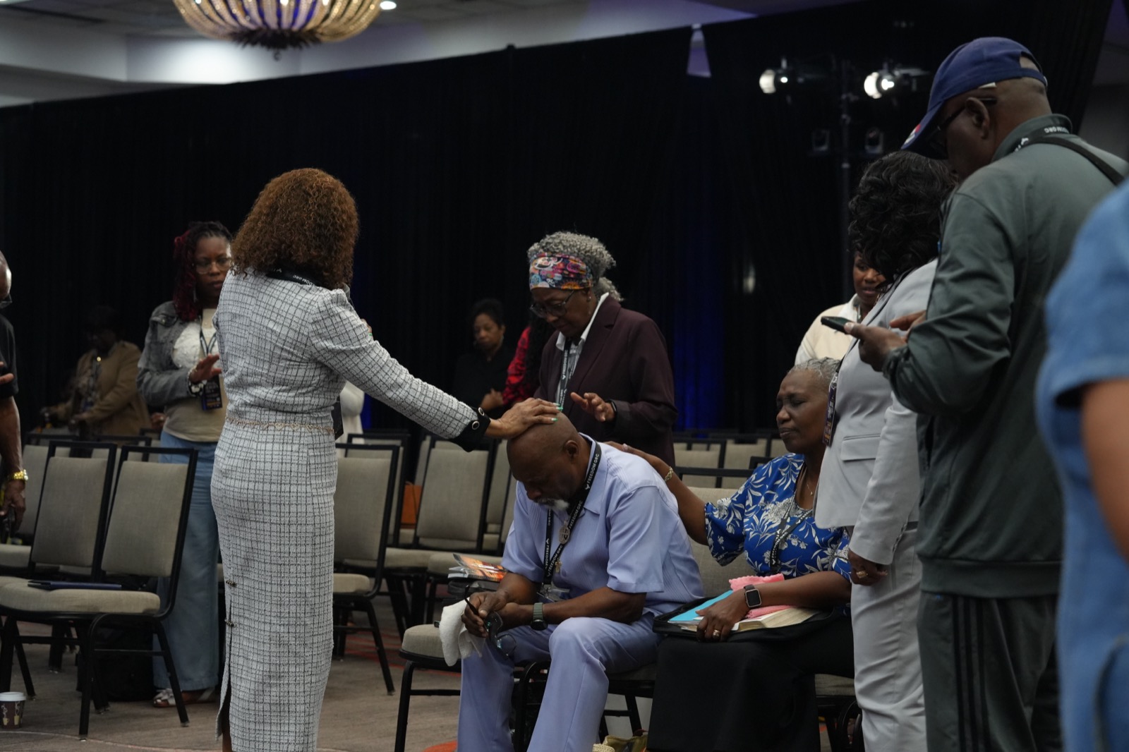 Convention guests support one another during a focused prayer moment