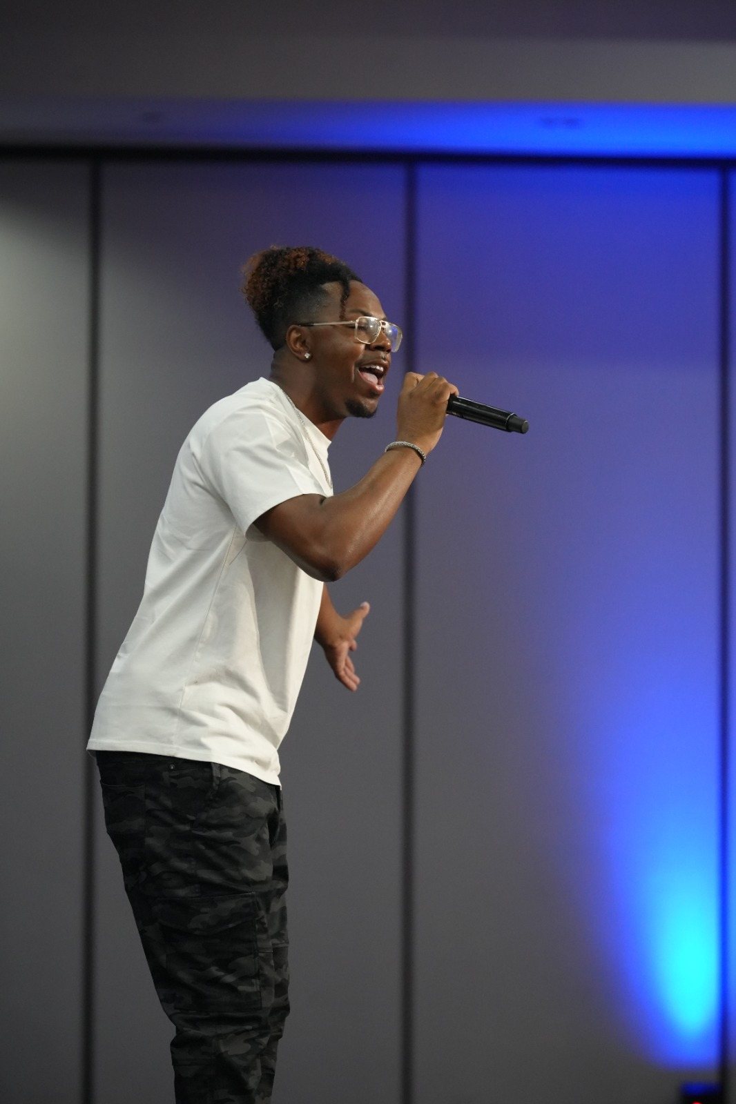 A worship leader sings during a convention gathering