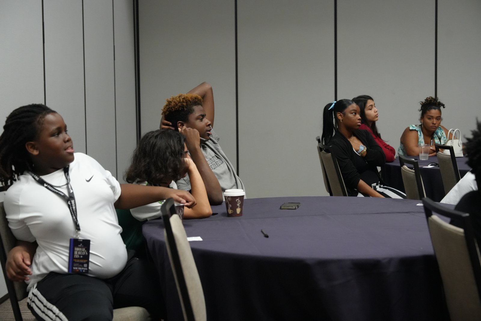 Teenagers listen during a NextGen session