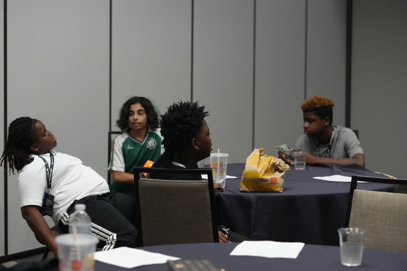 Young participants work through a guided discussion around a table